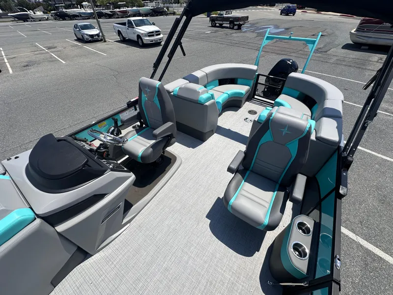 Slide: The Image of 2025 Berkshire 23RFX STS 3.0 pontoon boat with modern seating in a parking lot. - 8