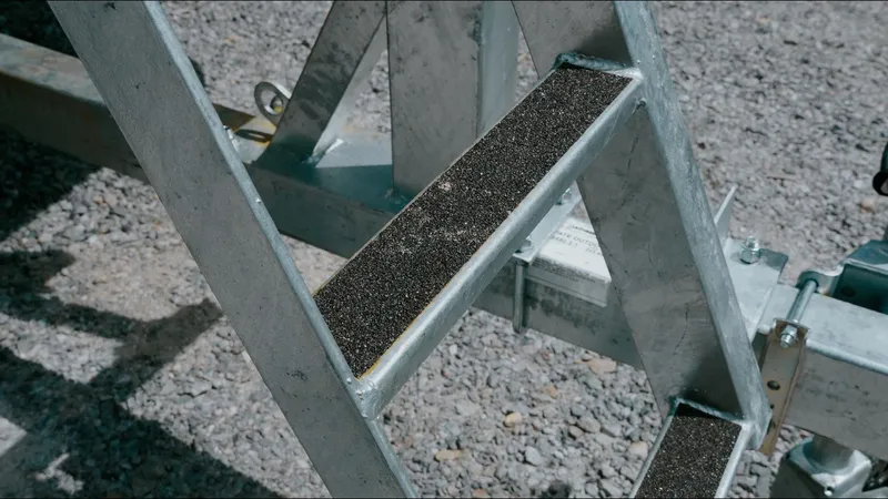 Slide: The Image of Metal ladder steps on a 2025 Tahoe Pontoon LTZ Cruise Rear Bench trailer. - 11