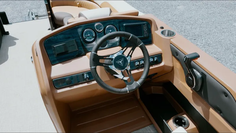 Slide: The Image of 2025 Tahoe Pontoon LTZ Cruise Rear Bench dashboard with steering wheel and controls. - 16