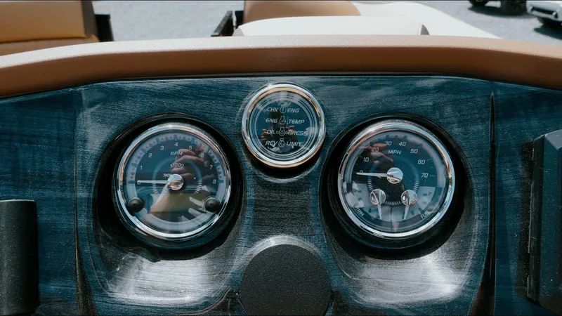 Slide: The Image of Dashboard of 2025 Tahoe Pontoon LTZ Cruise Rear Bench with gauges and controls. - 18