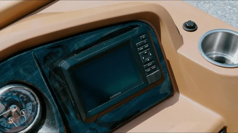 Slide: The Image of Dashboard of 2025 Tahoe Pontoon LTZ Cruise with Garmin display and cup holder. - 19