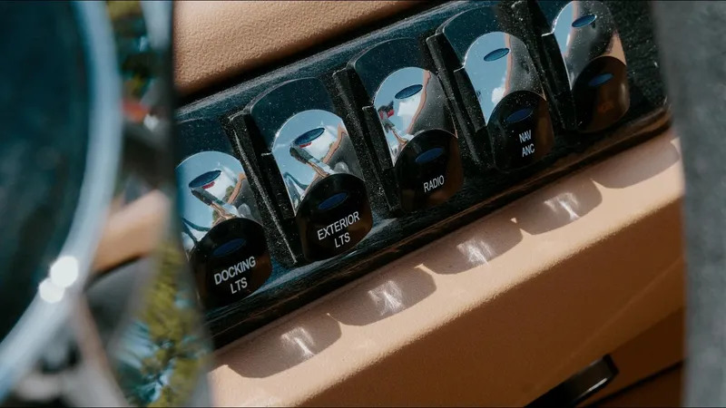 Slide: The Image of Control panel of 2025 Tahoe Pontoon LTZ Cruise Rear Bench with labeled switches. - 20