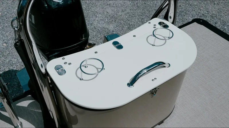 Slide: The Image of 2025 Tahoe Pontoon LTZ Cruise Rear Bench with cup holders and handle on deck. - 26