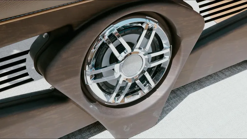 Slide: The Image of 2025 Tahoe Pontoon LTZ Cruise Rear Bench speaker detail, showcasing sleek design and chrome accents. - 30