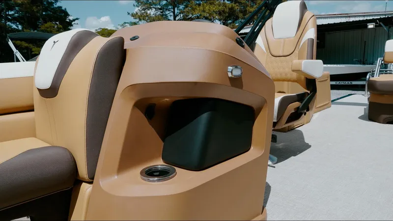 Slide: The Image of 2025 Tahoe Pontoon LTZ Cruise Rear Bench interior with tan and brown seating. - 31