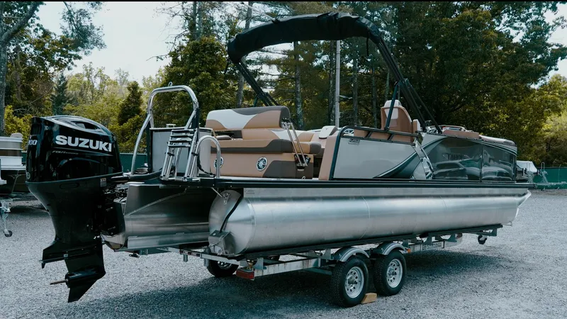Slide: The Image of 2025 Tahoe Pontoon LTZ Cruise Rear Bench on trailer, featuring Suzuki outboard motor. - 7