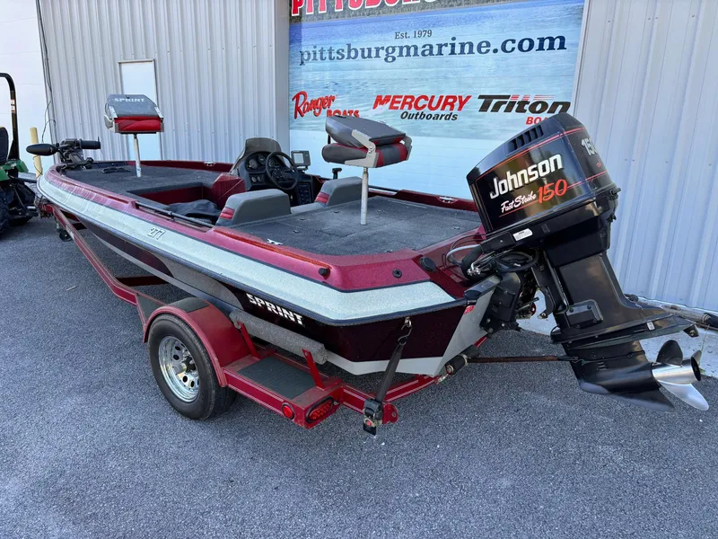 Slide: The Image of Red 1995 Sprint 277 boat with Johnson 150 motor, parked outside Pittsburg Marine. - 10