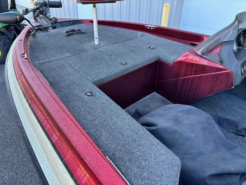 Slide: The Image of Red and gray deck of a 1995 Sprint 277 boat, featuring storage compartments. - 3