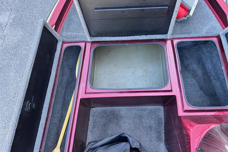 Slide: The Image of Interior of a 1995 Sprint 277 boat showing storage compartments and carpeted flooring. - 4