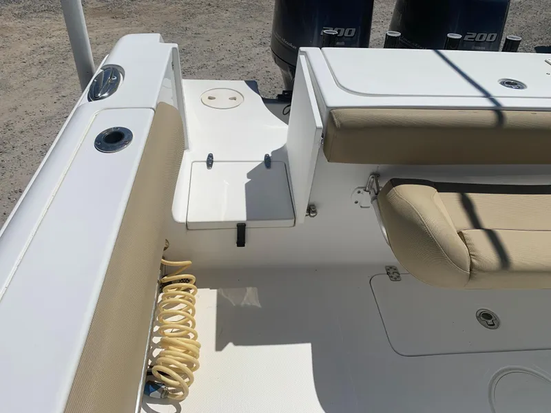 Slide: The Image of 2018 Sea Hunt Gamefish 27 boat interior with seating and dual engines. - 11