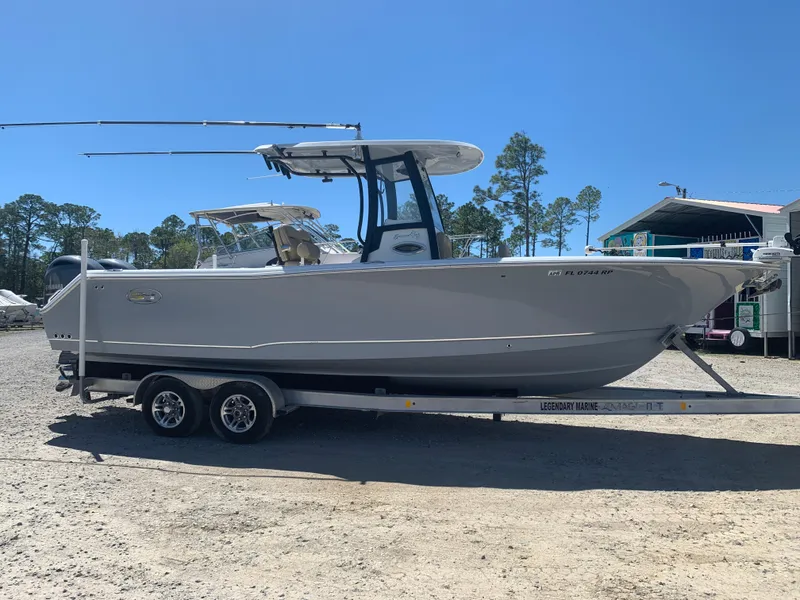 Slide: The Image of 2018 Sea Hunt Gamefish 27 boat on trailer, parked outdoors under clear sky. - 4