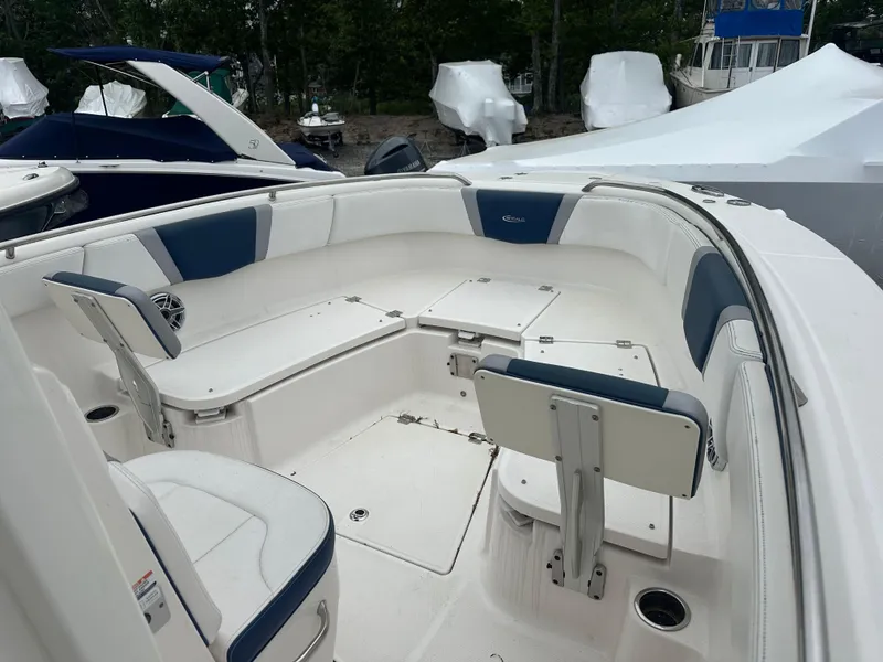Slide: The Image of 2021 Robalo R272 Center Console boat interior with white and blue seating. - 12