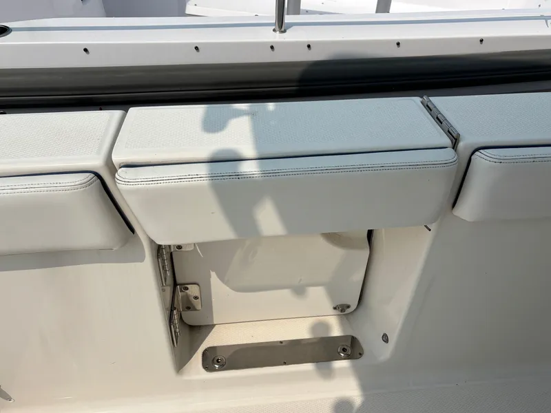 Slide: The Image of 2021 Robalo R272 Center Console boat seating and storage compartment. - 14