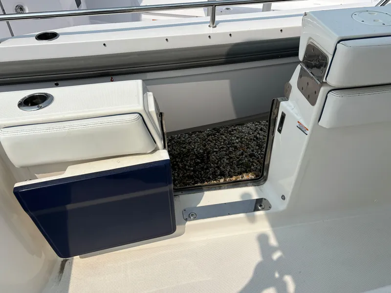 Slide: The Image of 2021 Robalo R272 Center Console boat interior with open side door. - 15