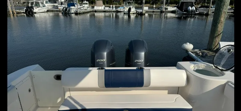 Slide: The Image of 2021 Robalo R272 Center Console boat with twin 200 engines docked at marina. - 16