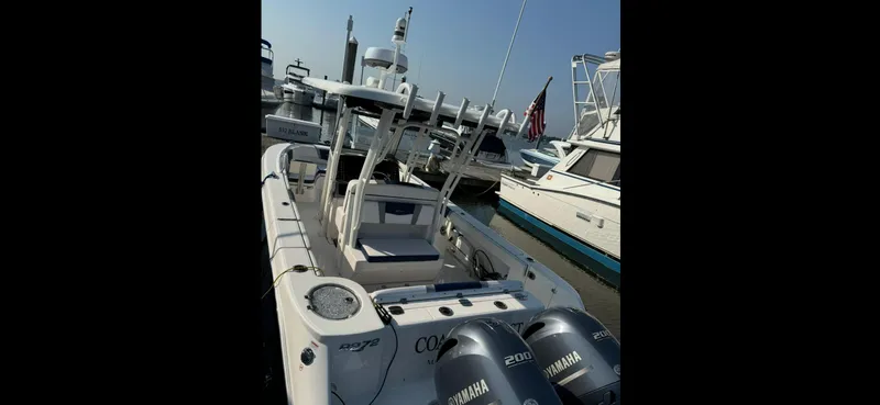 Slide: The Image of 2021 Robalo R272 Center Console boat docked with twin Yamaha engines. - 17