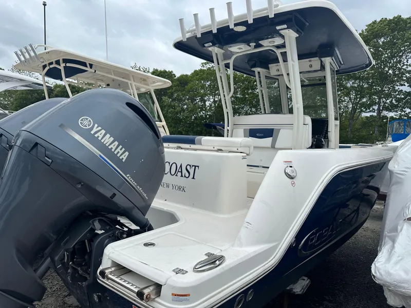Slide: The Image of 2021 Robalo R272 Center Console boat with Yamaha engine, docked outdoors. - 19