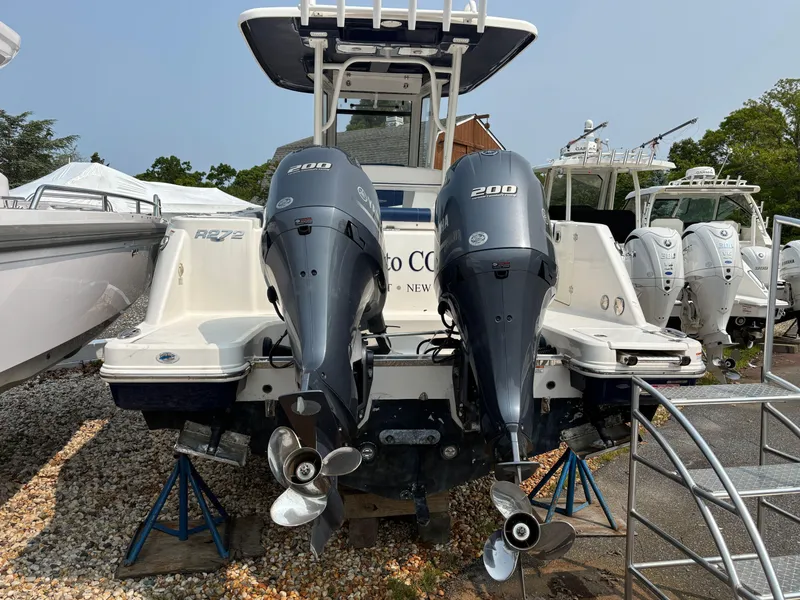 Slide: The Image of 2021 Robalo R272 Center Console boat with twin 200 horsepower engines, displayed outdoors. - 20