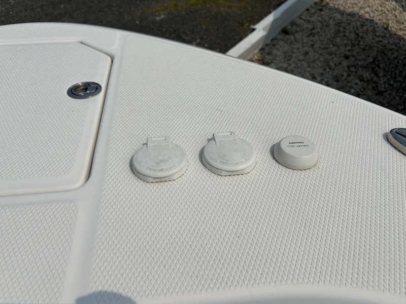 Slide: The Image of 2021 Robalo R272 Center Console deck with utility access covers. - 21
