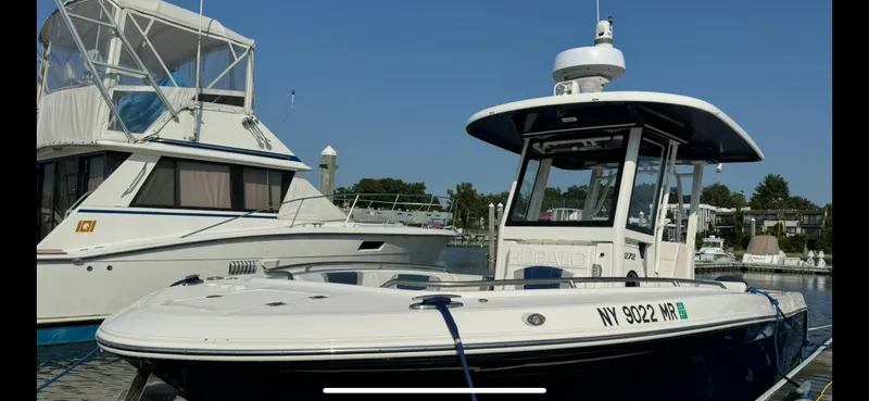 Slide: The Image of 2021 Robalo R272 Center Console boat docked at marina. - 3