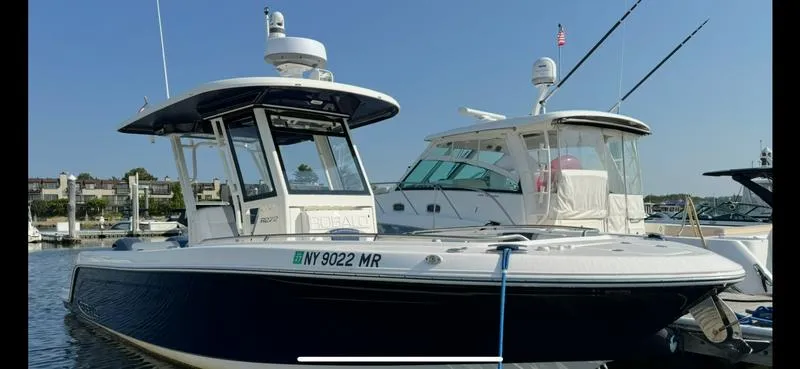 Slide: The Image of 2021 Robalo R272 Center Console boat docked at a marina. - 4