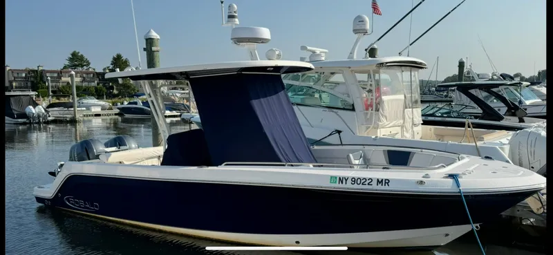 Slide: The Image of 2021 Robalo R272 Center Console boat docked in marina, side view. - 5