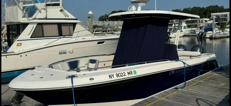 Slide: The Image of 2021 Robalo R272 Center Console boat docked at marina. - 6