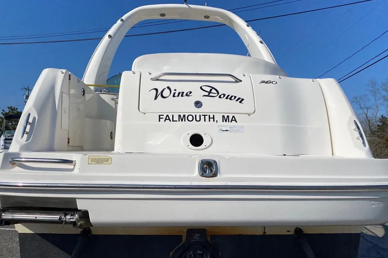 Slide: The Image of 2007 Sea Ray 260 Sundancer docked at marina, featuring sleek design and white exterior. - 1