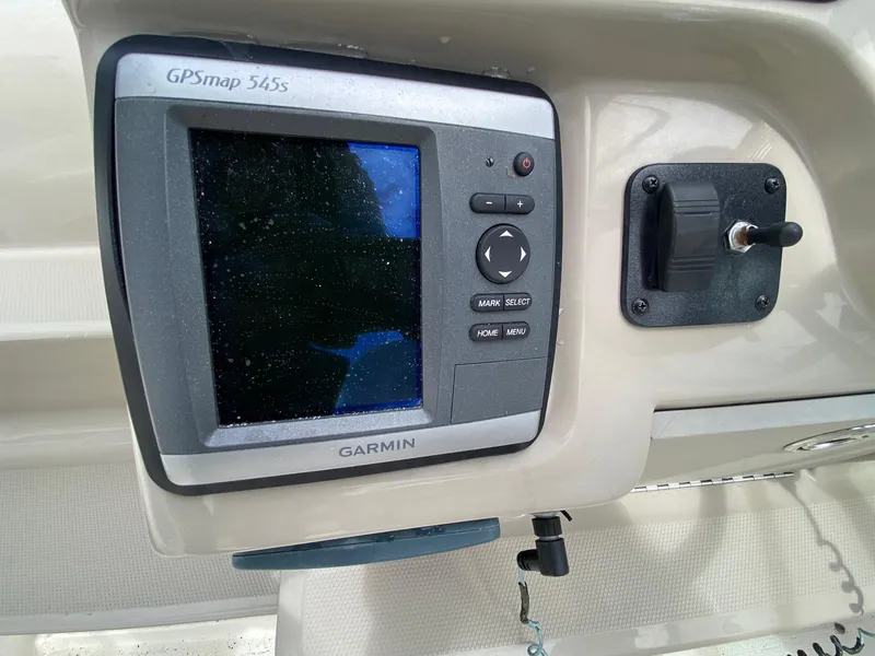 Slide: The Image of 2007 Sea Ray 260 Sundancer boat interior with seating, helm, and sink. - 13