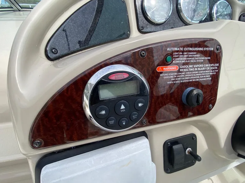 Slide: The Image of 2007 Sea Ray 260 Sundancer boat interior with white seating and helm. - 15