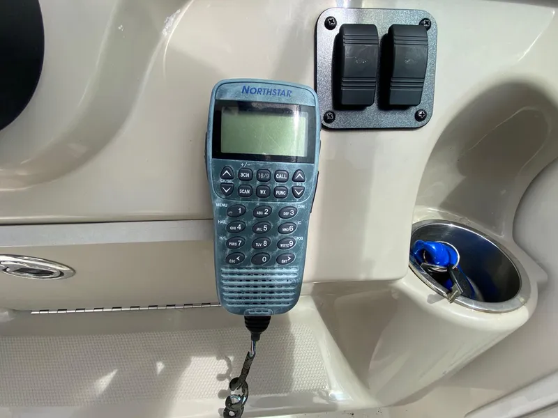 Slide: The Image of 2007 Sea Ray 260 Sundancer boat interior with white seating and control panel. - 16