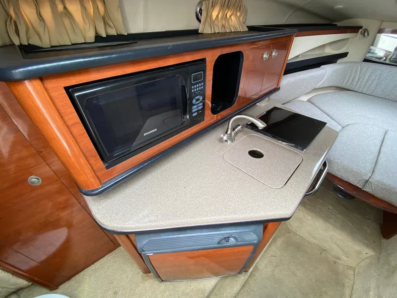 Slide: The Image of 2007 Sea Ray 260 Sundancer cockpit with steering wheel, gauges, and white seating. - 17