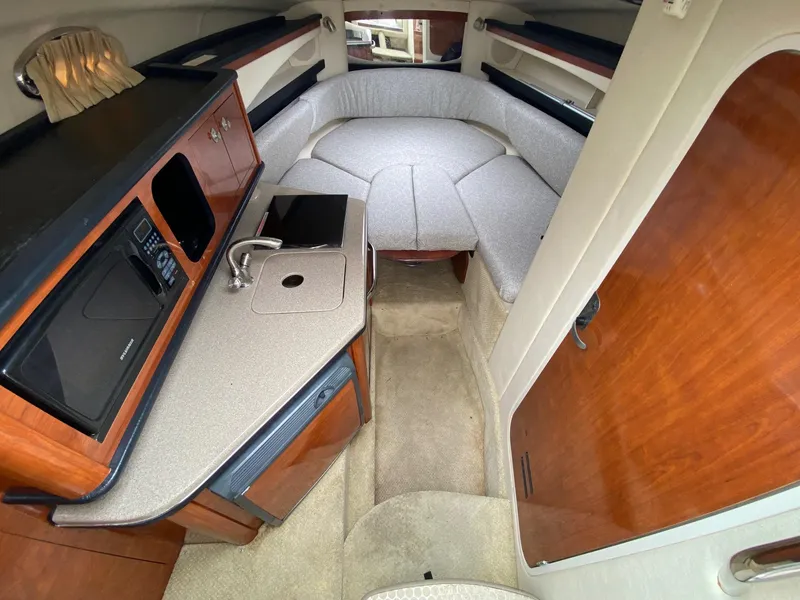 Slide: The Image of 2007 Sea Ray 260 Sundancer boat interior with white seating and helm. - 18