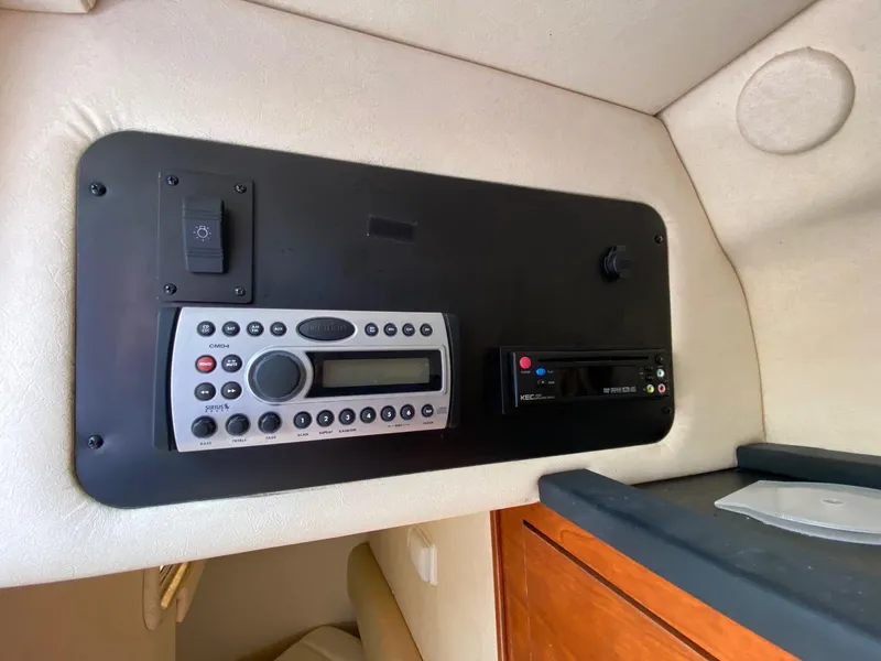 Slide: The Image of Control panel of a 2007 Sea Ray 260 Sundancer boat with warning labels and audio controls. - 20