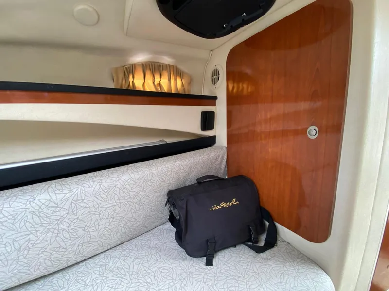 Slide: The Image of Control panel of a 2007 Sea Ray 260 Sundancer boat with gauges and warning labels. - 21