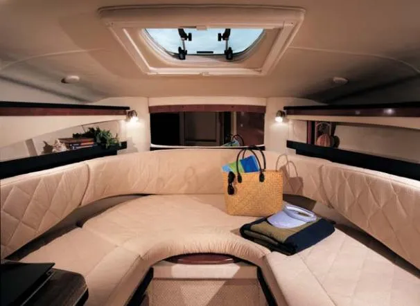 Slide: The Image of 2007 Sea Ray 260 Sundancer cabin with kitchenette, featuring microwave, sink, and seating area. - 23