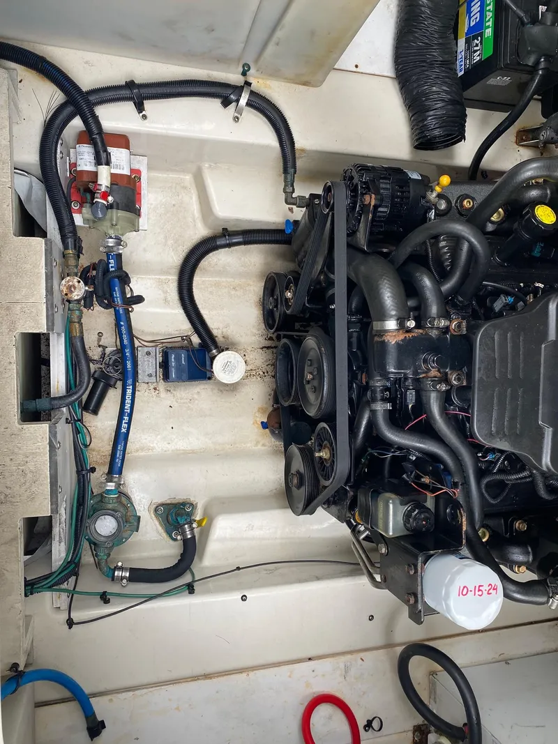 Slide: The Image of 2007 Sea Ray 260 Sundancer interior kitchen with microwave, sink, and stove. - 25