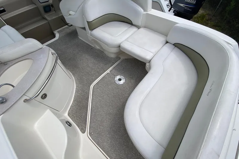Slide: The Image of 2007 Sea Ray 260 Sundancer interior with white seating and carpeted floor. - 36