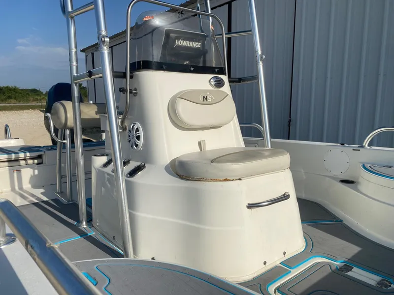 Slide: The Image of 2015 NauticStar 2200 Sport boat interior with seating and console, featuring Lowrance equipment. - 10