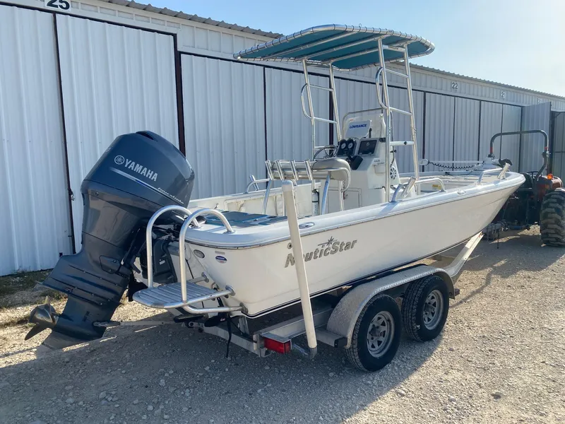 Slide: The Image of 2015 NauticStar 2200 Sport boat with Yamaha outboard motor on a trailer. - 5