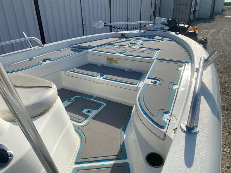 Slide: The Image of 2015 NauticStar 2200 Sport boat interior with seating and storage compartments. - 6