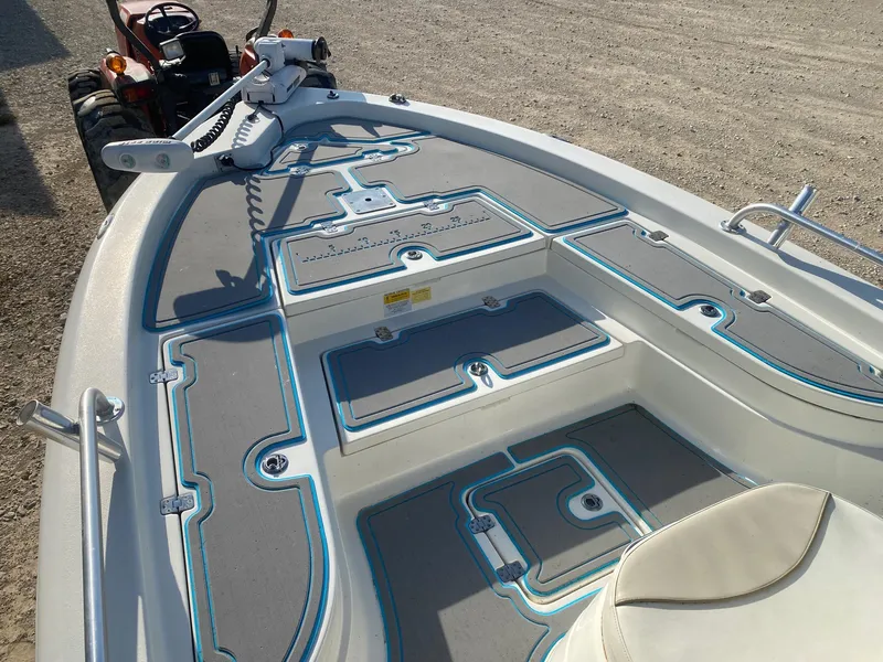 Slide: The Image of 2015 NauticStar 2200 Sport boat interior with seating and storage compartments. - 9