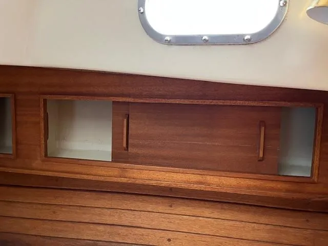 Slide: The Image of 1978 Bristol 29.9 interior with wooden cabinets and porthole window. - 10