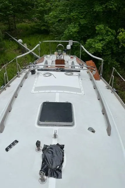 Slide: The Image of 1978 Bristol 29.9 sailboat deck with lush green surroundings. - 3