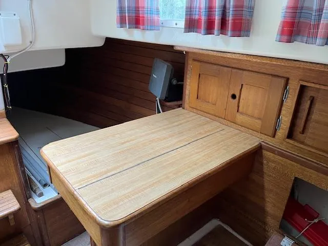 Slide: The Image of 1978 Bristol 29.9 sailboat interior with wooden table and storage cabinets. - 8