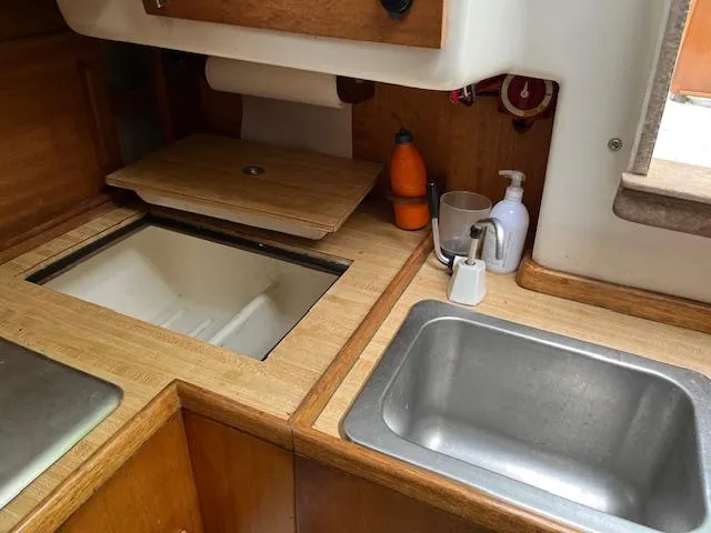 Slide: The Image of 1978 Bristol 29.9 yacht kitchen with sink, countertop, and storage. - 9