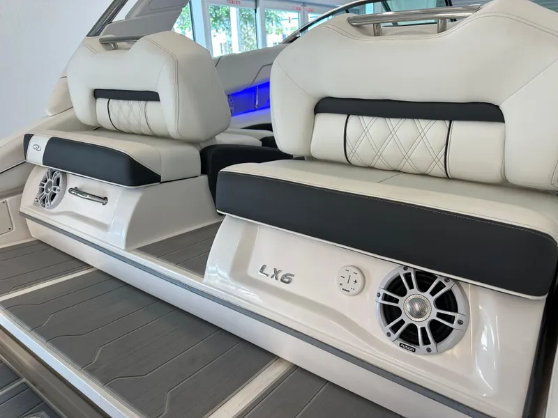 Slide: The Image of 2025 Regal LX6 boat displayed indoors, showcasing sleek design and modern features. - 13