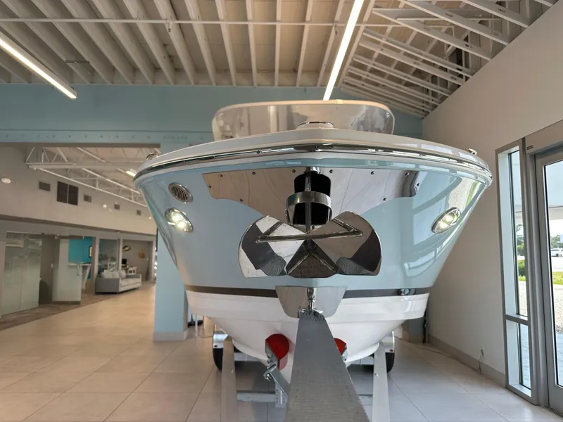 Slide: The Image of 2025 Regal LX6 boat interior with compact bathroom, featuring a sink and toilet. - 14