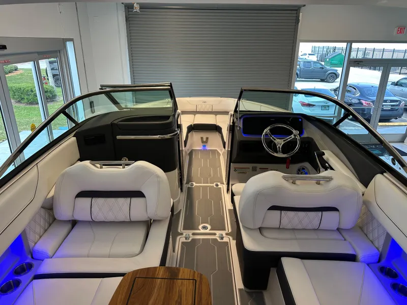 Slide: The Image of 2025 Regal LX6 boat interior with white seating and blue LED lighting. - 6