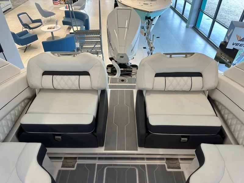 Slide: The Image of 2025 Regal LX6 boat interior with plush seating and ambient blue lighting. - 8